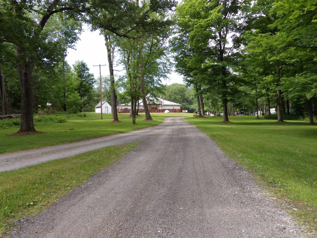A photo of an unpaved pathway at Whispering Woods Campground